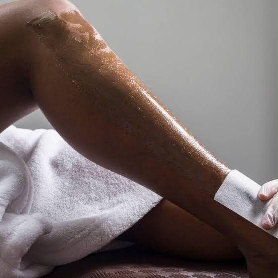 Close up detail of a waxing strip being applied during a leg waxing treatment