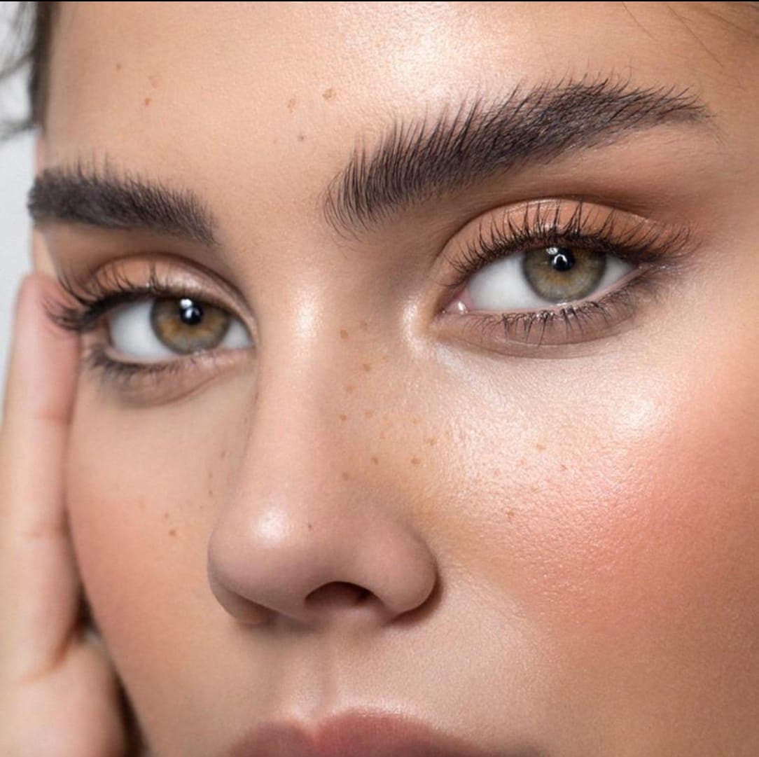 Close up of freshly finished, well shaped brows and smooth skin