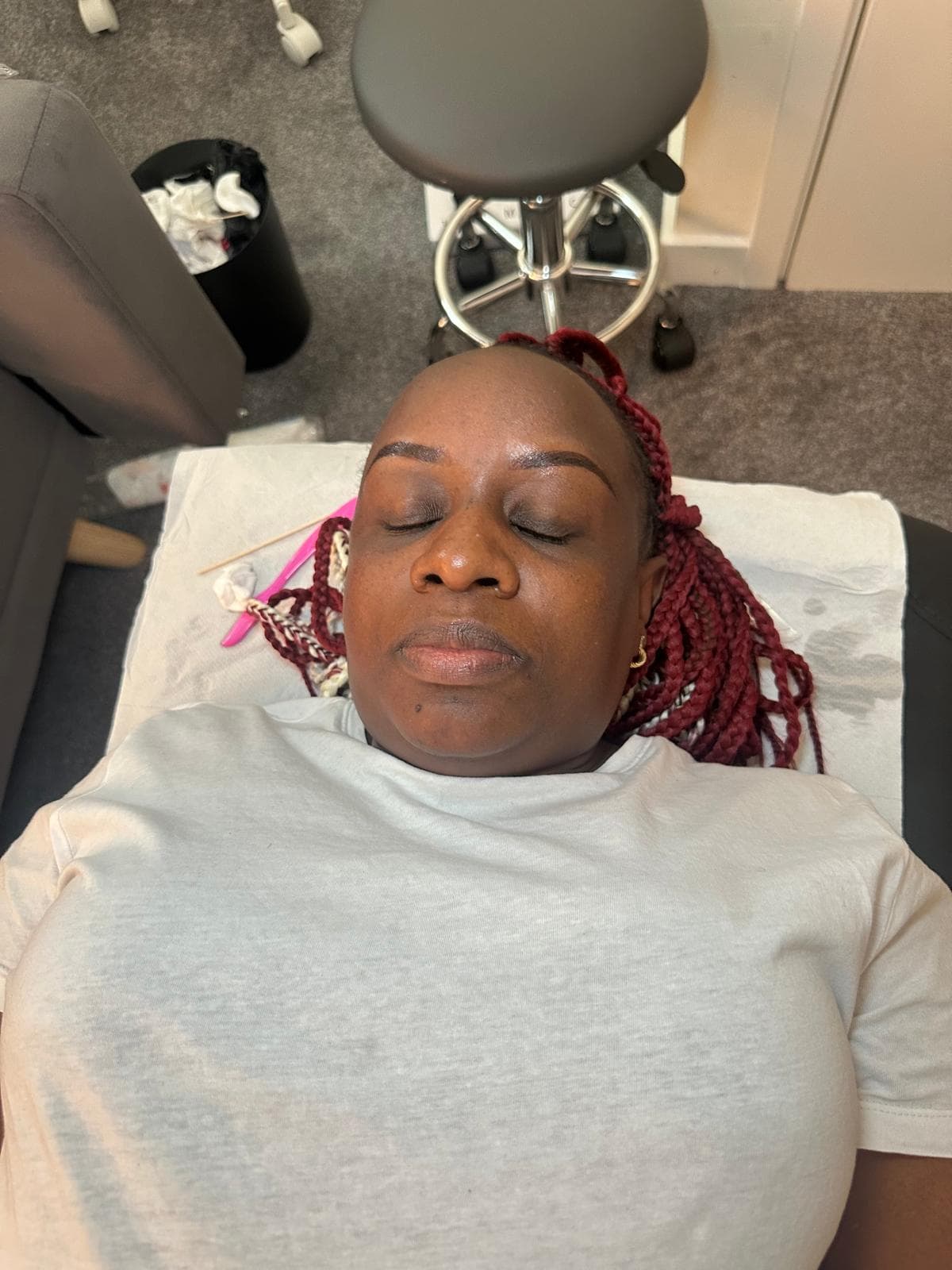 Client resting after a treatment with a soft studio setup